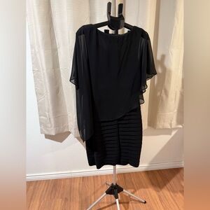 Black dress with a small cape.